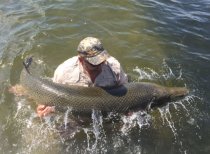 Capt. Andy Jones gets up close and personal with a big alligator gar in Lake Pontchartrain on Friday. Jones said the gar measured 6 feet, 9 inches, and weighed between 160 and 180 pounds.